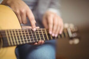 Guitar Tutor shows pupil a chord