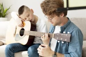 Guitar tutor | Boy learning how play guitar